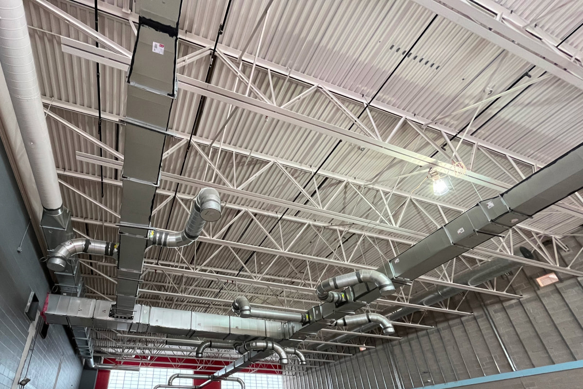 Industrial HVAC ductwork installed in exposed steel ceiling