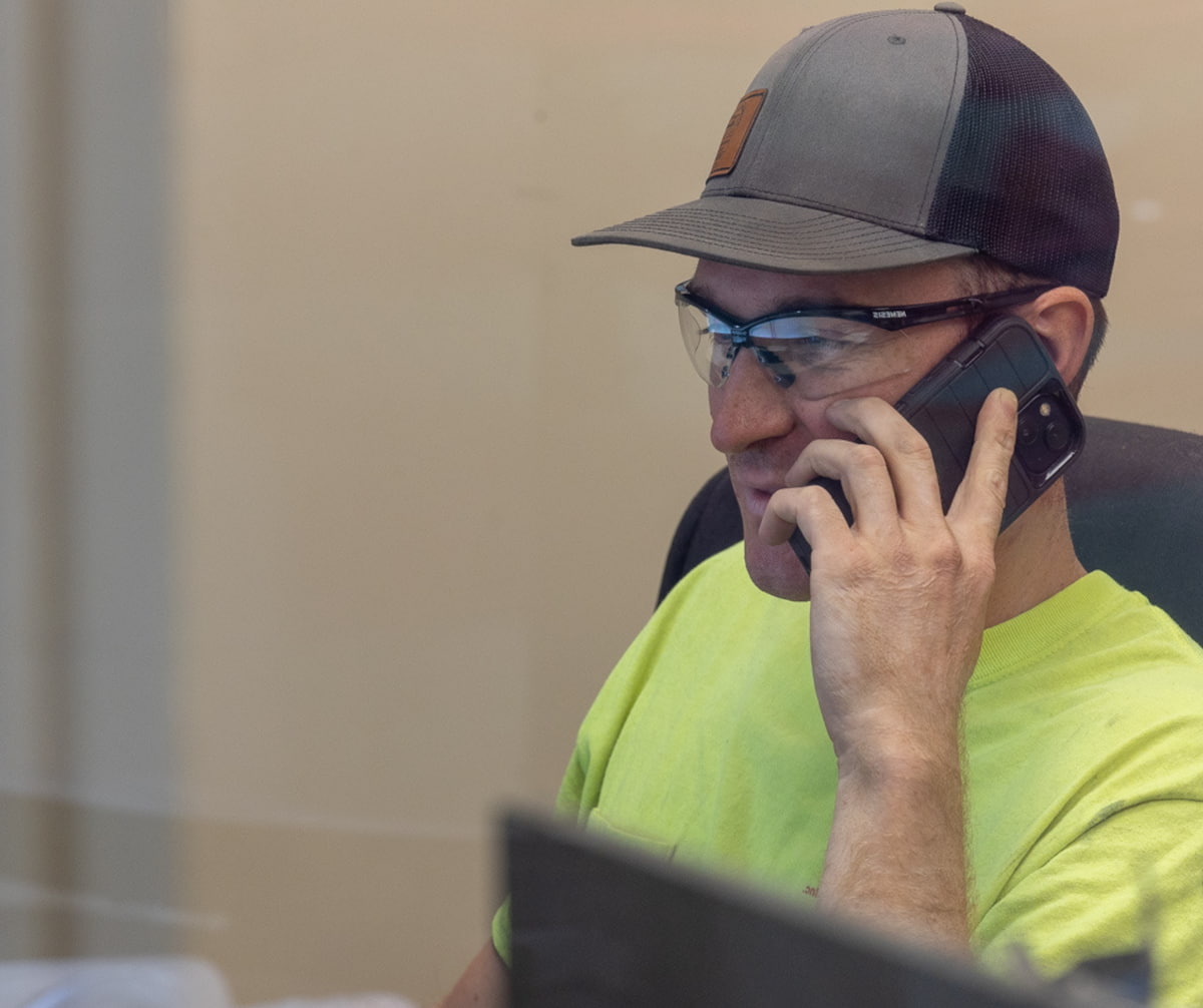 Joe Van Den Elzen on the phone at his desk