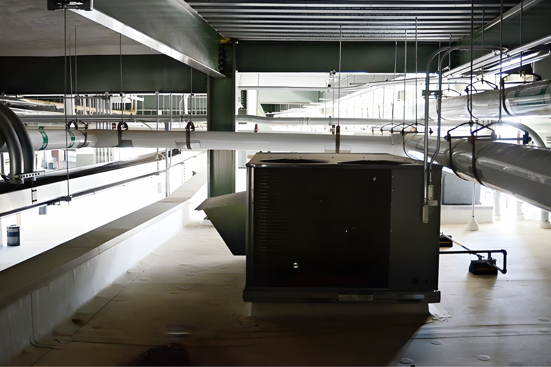 Commercial HVAC unit and overhead ductwork installed inside Lambeau Field facility