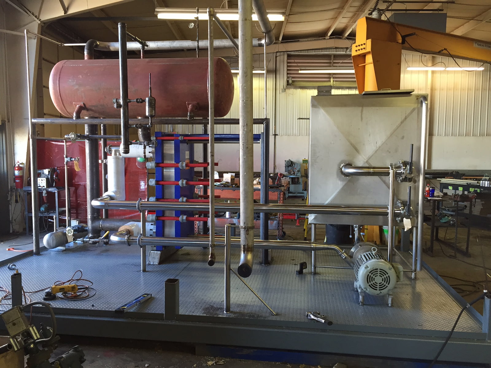 Refrigeration system setup in progress for Saputo Cheese chiller room featuring piping and pumps