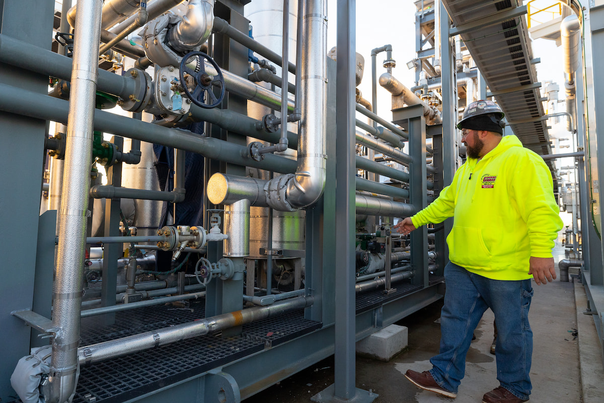 Two Hurckman employees reviewing piping system on a jobsite