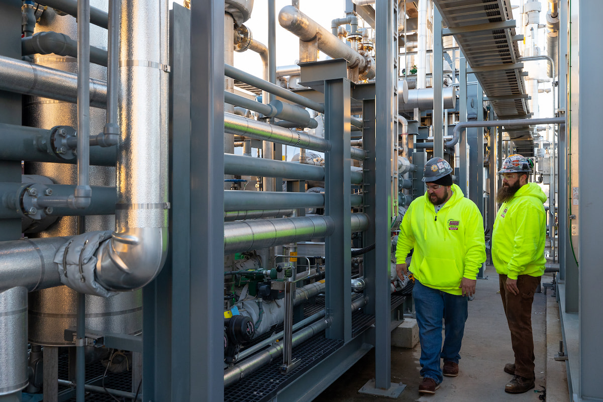 Two Hurckman employees reviewing piping system at a jobsite