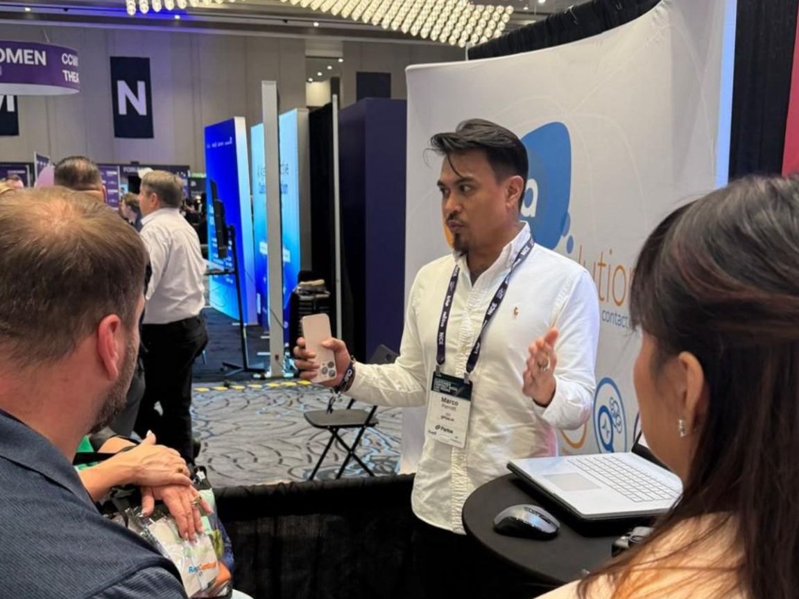 Marco Perrott talking with visitors at an expo booth