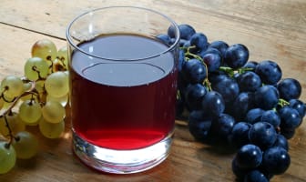 Verre de jus de raisin et grappes