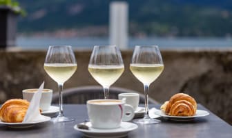 Verres de prosseco, expresso et croissants sur table