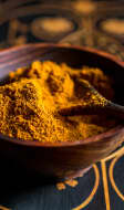 Ras el hanout dans un bol en bois avec une cuillère