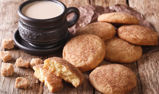 Snickerdoodles et café au lait sur table en bois.