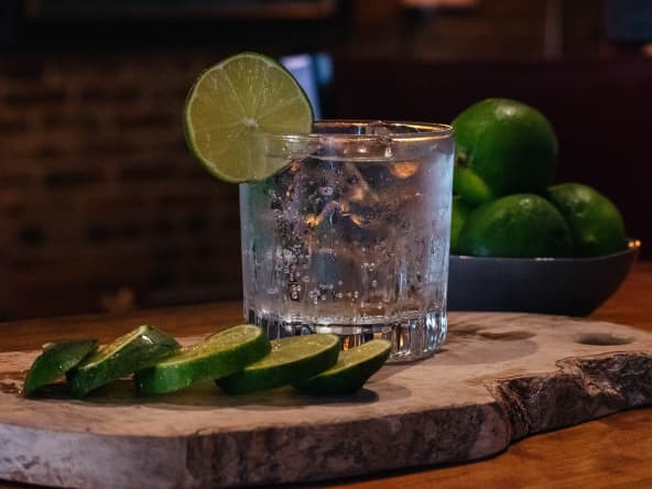 Verre de cocktail gin tonic et rondelles de citron vert