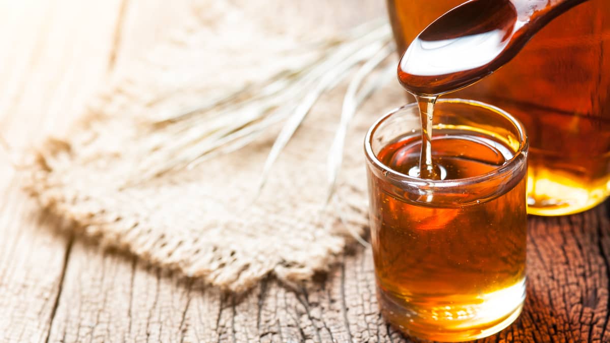 Sirop d'érable dans une bouteille en verre sur une table en bois