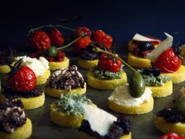 Canapés de polenta, ricotta et parmesan, tomates séchées et tomates confites, câpres et olives noires