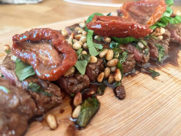 Tataki de boeuf aux saveurs italiennes avec pignons de pin, basilic et tomates séchées