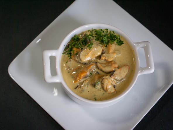 Cassolette de moules sur assiette blanche