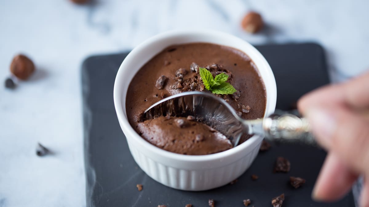 Gros plan sur un petit pot de mousse végétale chocolat praliné