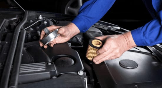 mechanic changing fuel filter