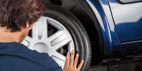 mechanic changing a hubcap