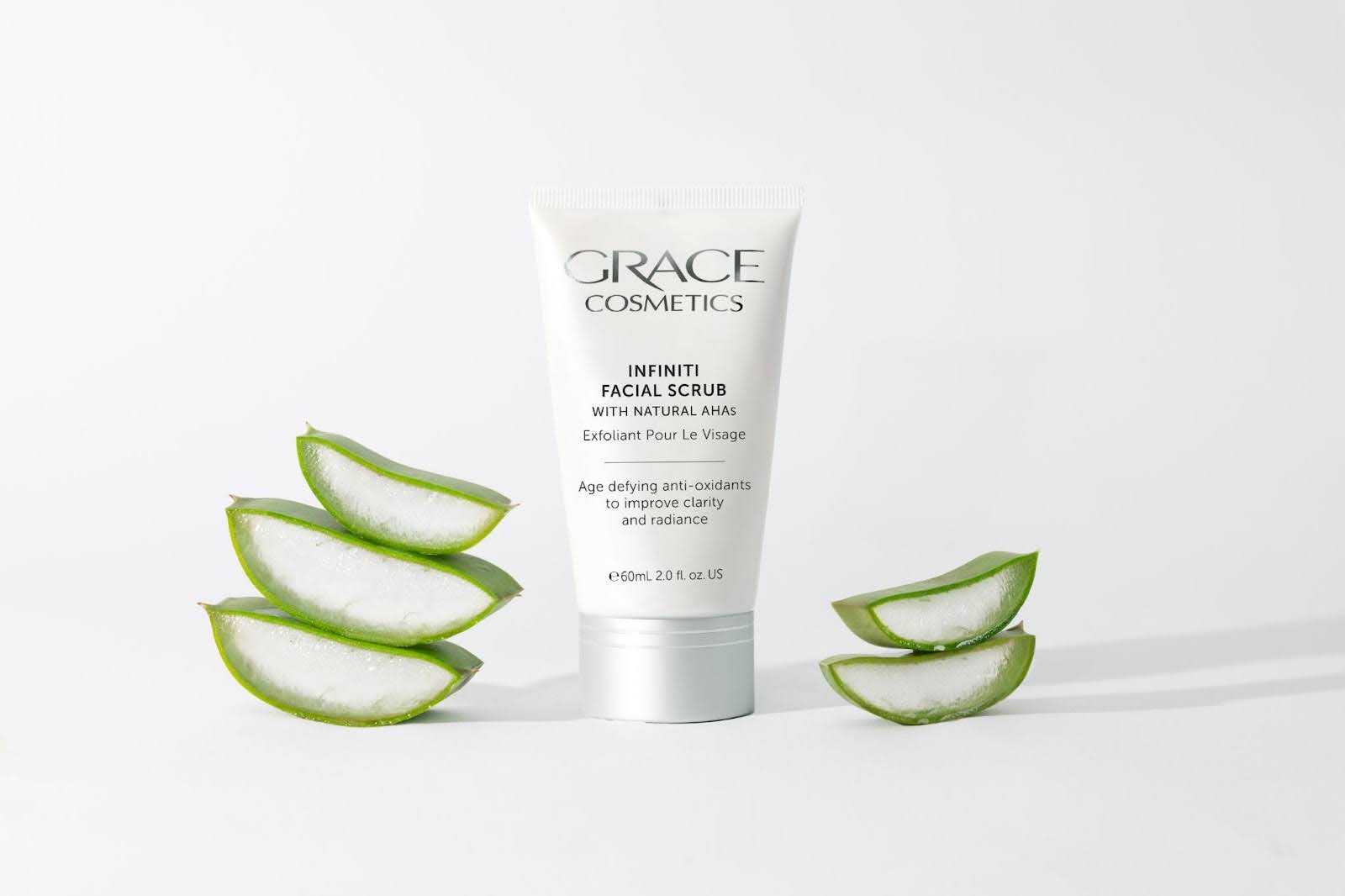 Grace Cosmetics Infiniti Facial Scrub Product close up surrounded by pieces of aloe vera
