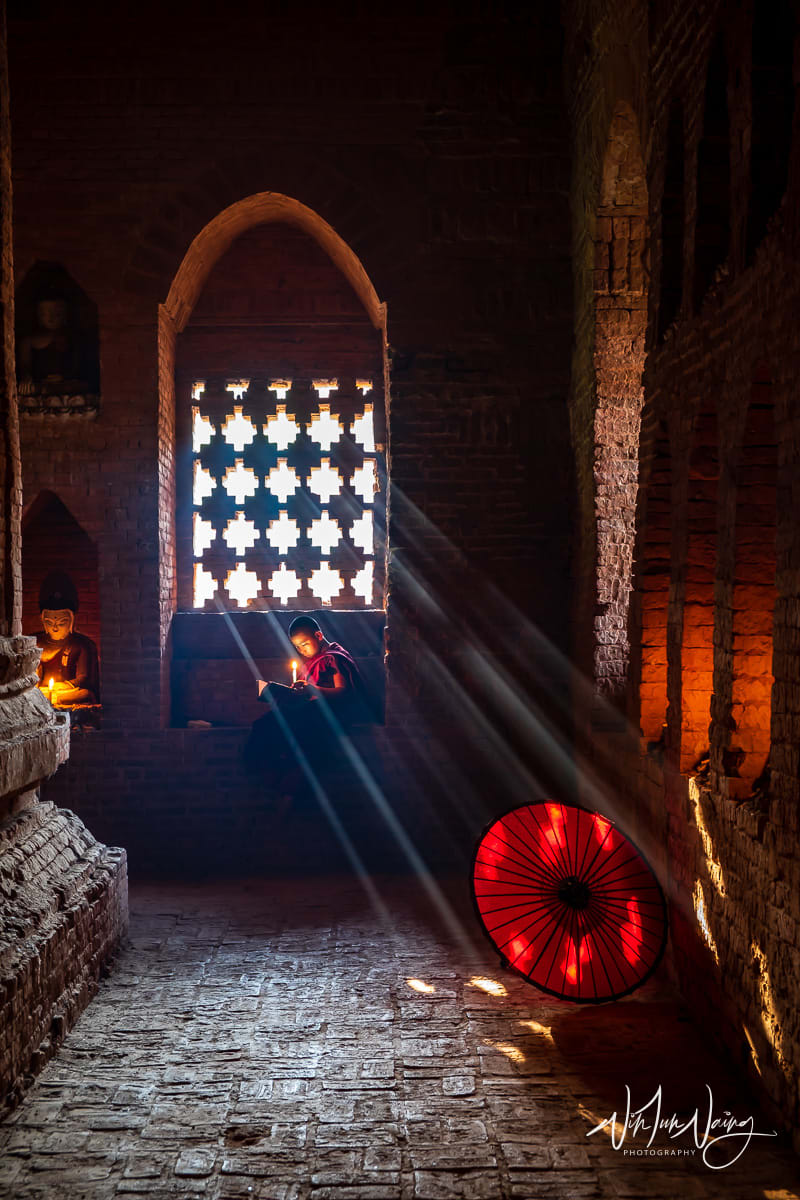 A novice reading a book in old temple
