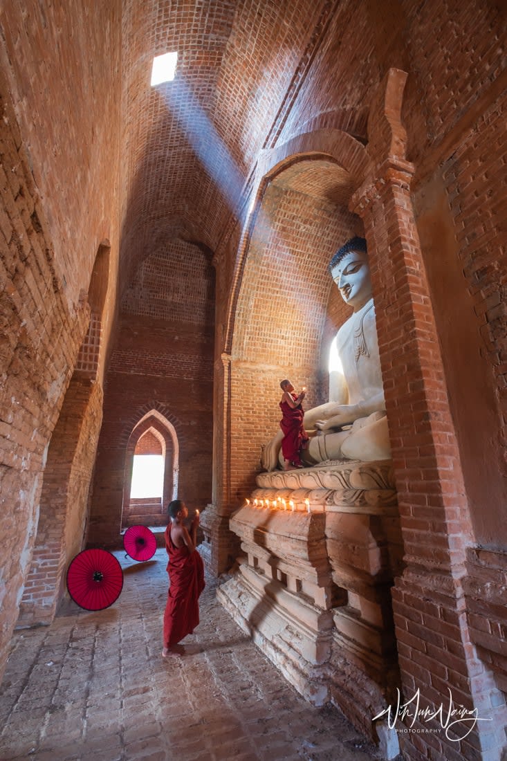 Novices praying with candle in Bagan