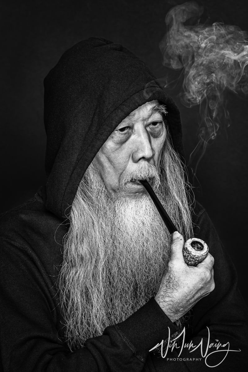 Man with A Long Beard Smoking a Pipe