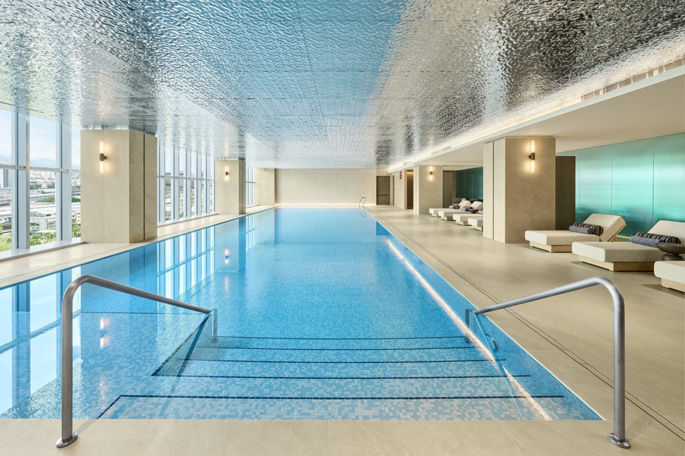 Indoor pool at the InterContinental Taipei beneath a rippling metal ceiling