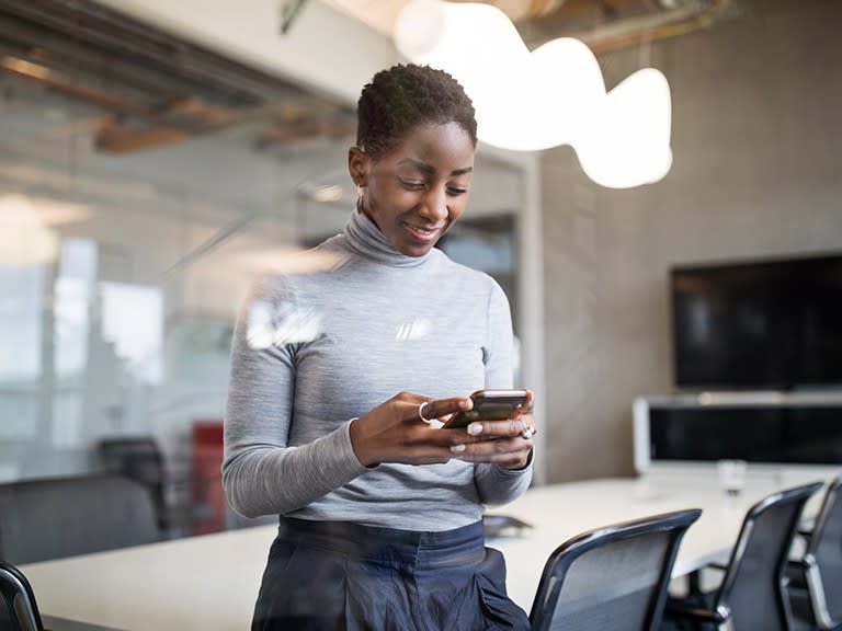 An HSBC colleague using a mobile device