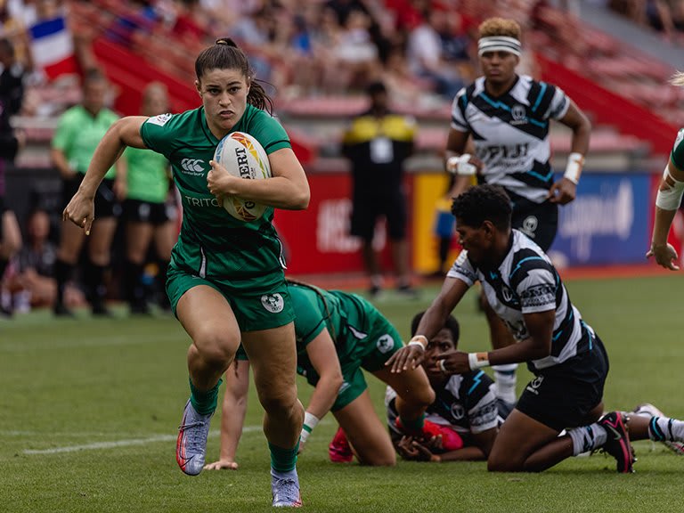 A rugby sevens player running with the ball
