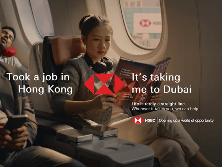 A traveller reading on a flight, from the HSBC ‘Pivot’ campaign