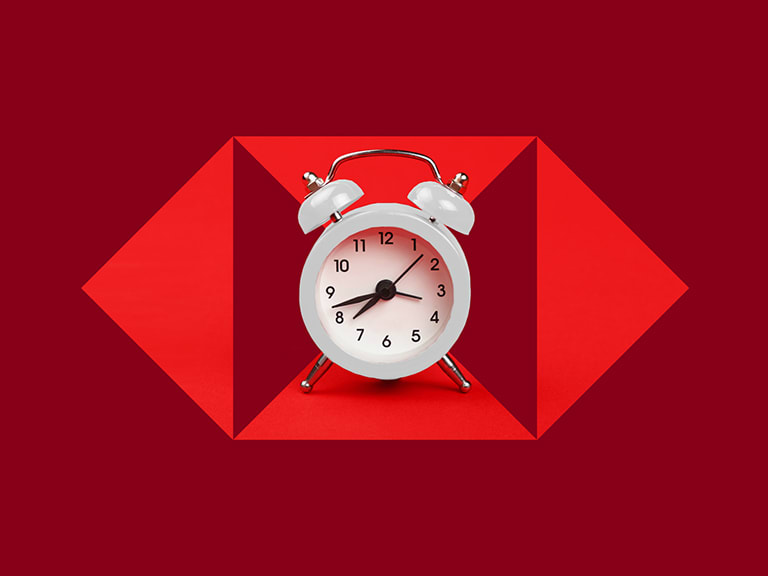 An alarm clock on a red HSBC hexagon graphic