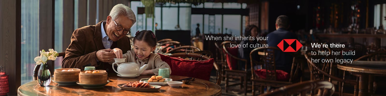 A grandfather and granddaughter sharing dim sum