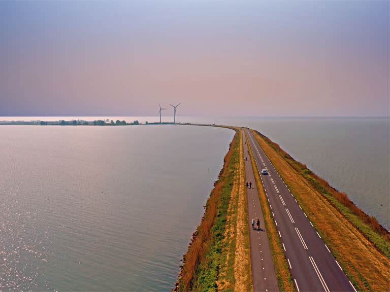 Wind turbines beside a coastal road
