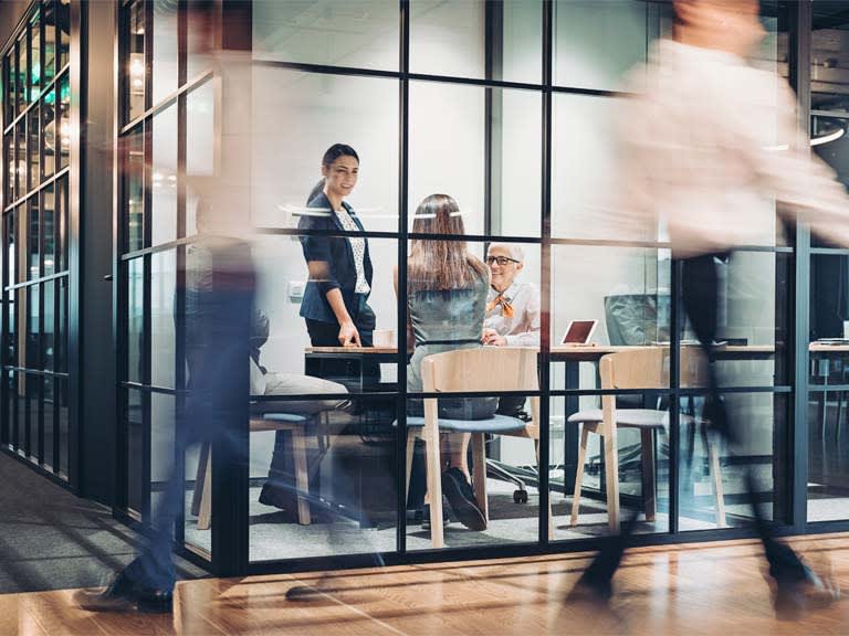 Colleagues walking through a modern HSBC office
