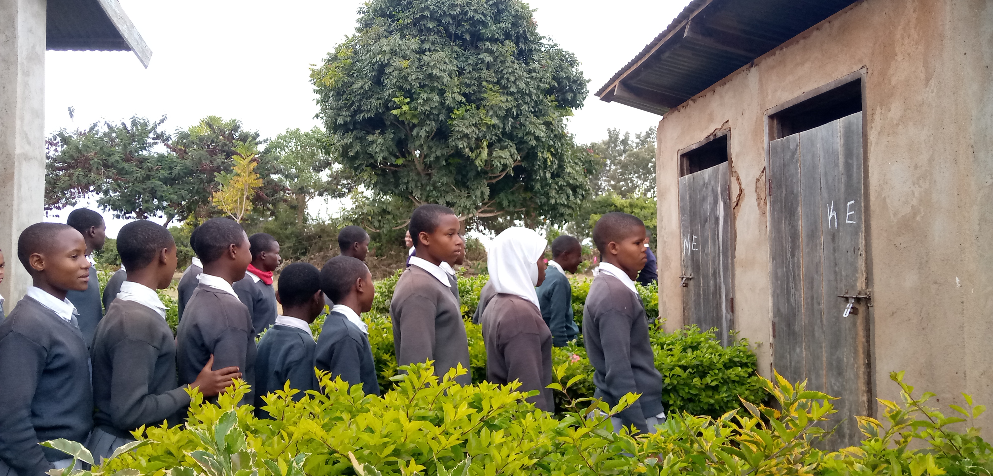 6.31 - Project 2021 - Tsaayo Secondary bathrooms-Students line up to enter bathrooms they share with teachers 06.jpg