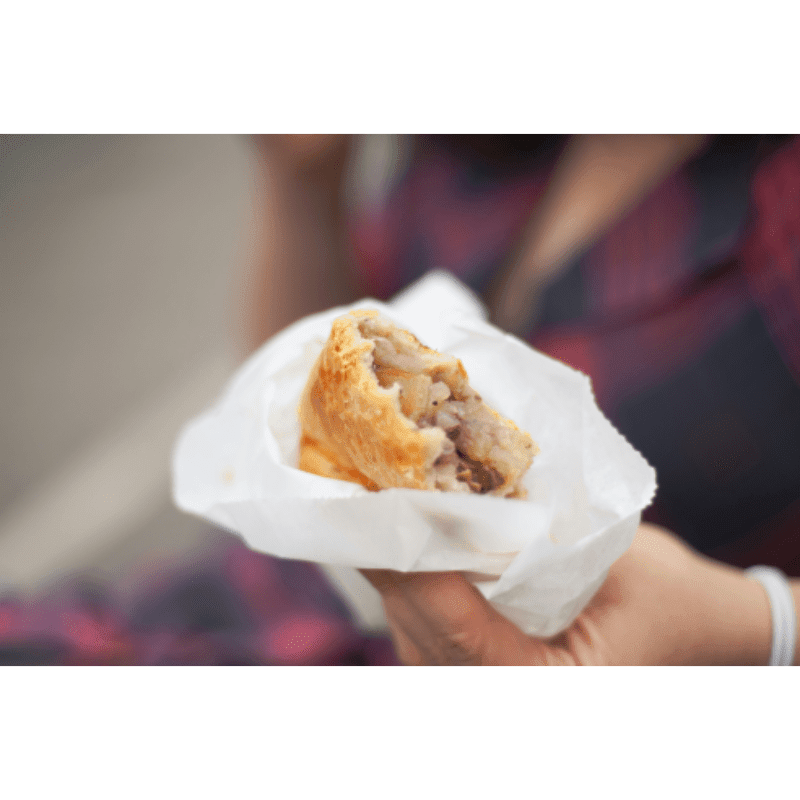 a close up of a person holding a pastry