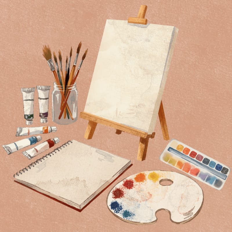 A blank canvas on an easel stands behind a collection of art supplies including paint tubes, brushes in a jar, a sketchbook, a watercolor palette, and a paint palette, all set against a textured, peachy background.