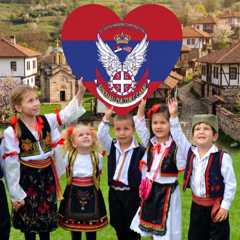 Five children in traditional Serbian attire hold up a heart-shaped flag with a crest in front of a picturesque village with stone houses and a church.