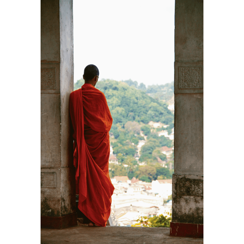 a person in a red robe looking out of a doorway