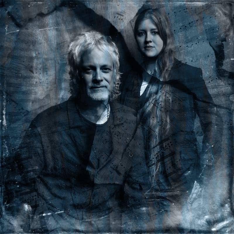 A man and a woman are superimposed over a textured background of faded sheet music.