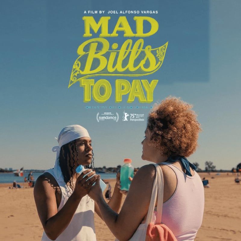 Two women with drinks stand on a sandy beach with a clear blue sky and distant boats in the background, under a movie title.