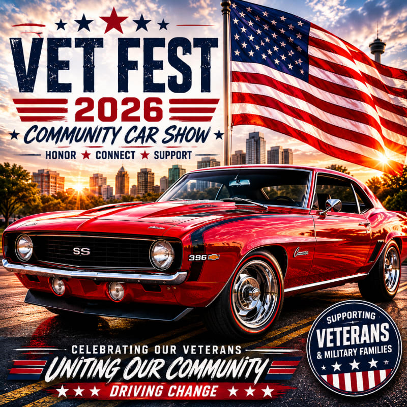 A gleaming red 1969 Camaro SS is parked in front of a large American flag and a city skyline at sunset, advertising "Vet Fest 2026 Community Car Show."