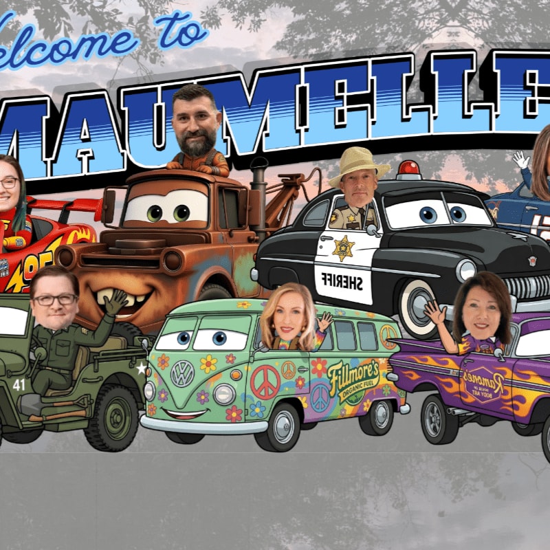 Cartoon characters with human faces are superimposed on various vehicles in the foreground, with a "Welcome to Maumelle" banner and trees in the background.