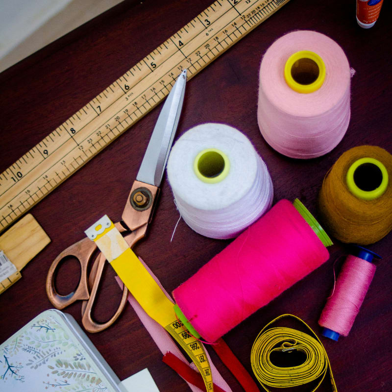 threads with spools beside scissors