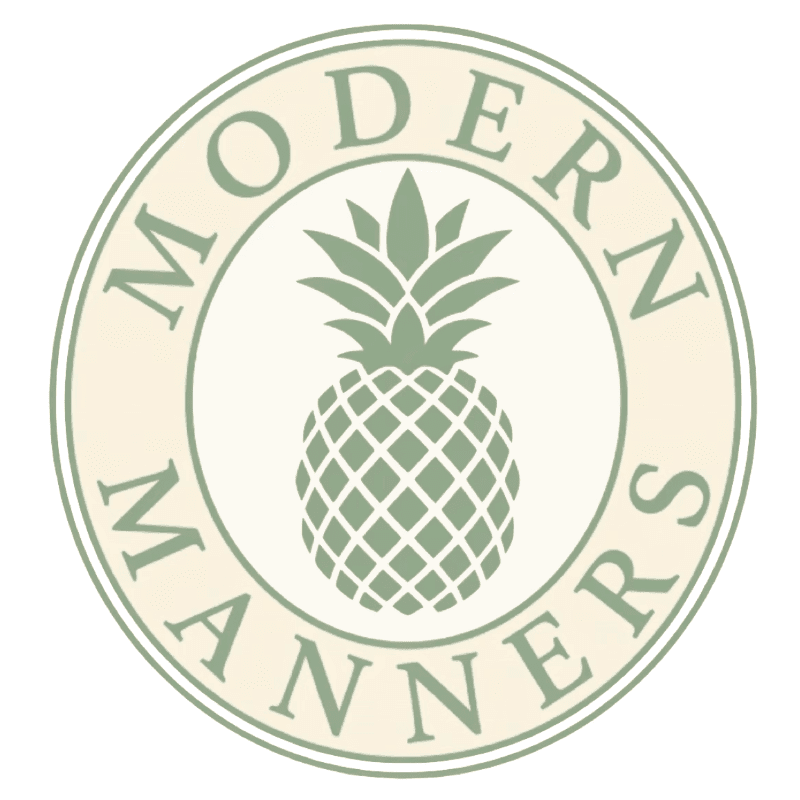 A green pineapple is centered within a cream-colored circle that has the words "MODERN MANNERS" inscribed around it.