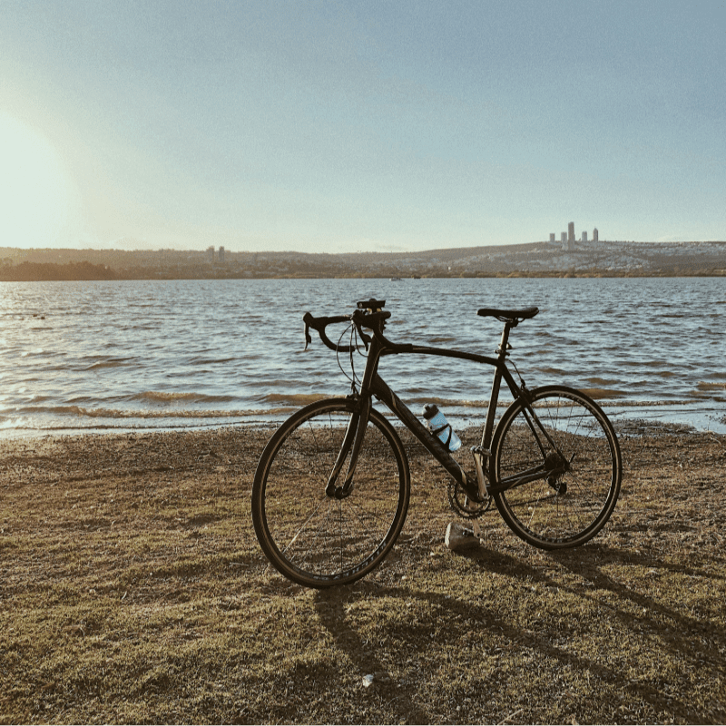 a bicycle is parked next to a body of water