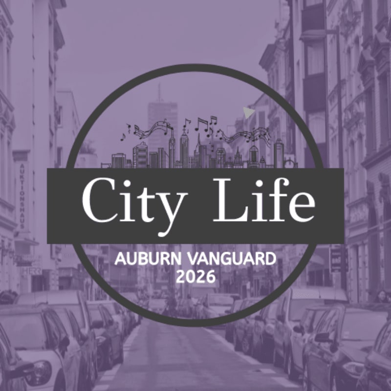 A circular logo with "City Life" and "Auburn Vanguard 2026" overlays a blurred background of a street lined with parked cars and buildings.