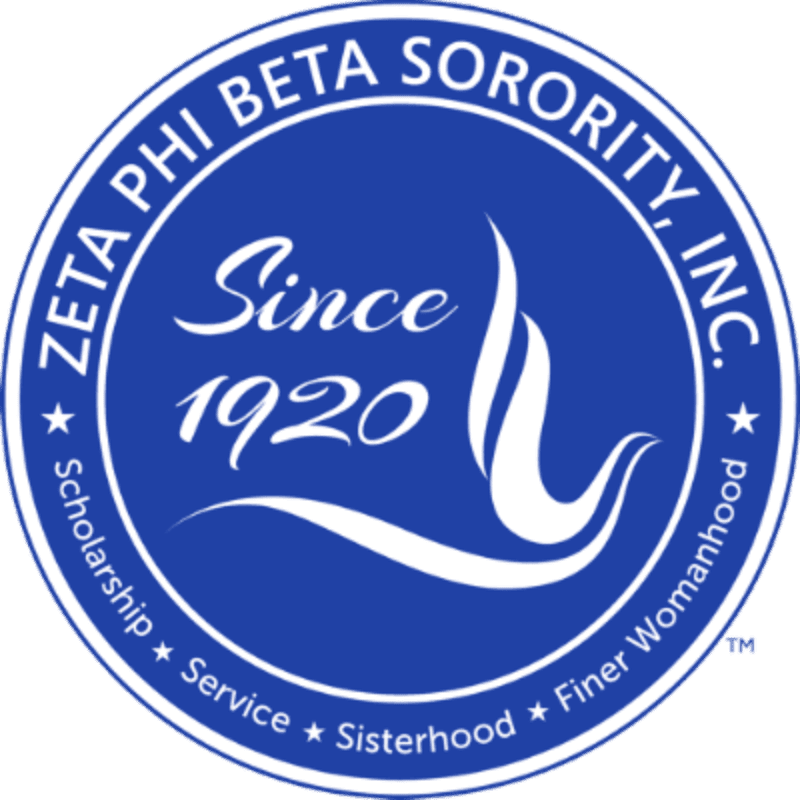 A blue circular emblem features the text "ZETA PHI BETA SORORITY, INC." around the top, "Since 1920" in script in the center, and "Scholarship Service Sisterhood Finer Womanhood" around the bottom, all against a white background.