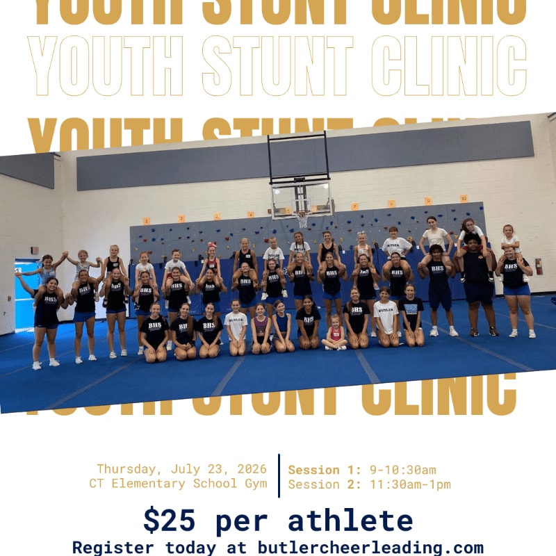 A group of young athletes in athletic wear pose for a photo in a school gymnasium, with a large "YOUTH STUNT CLINIC" banner visible in the background.