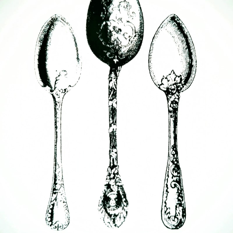 Three ornate spoons with detailed handles and bowls are presented against a plain white background.