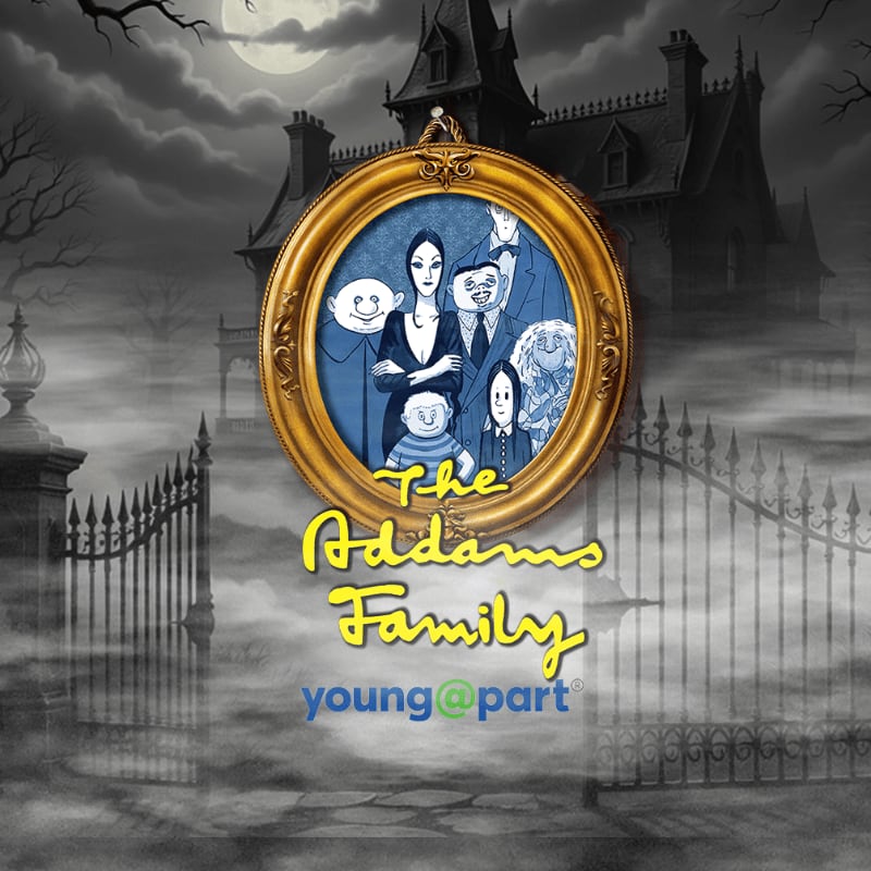 A framed portrait of the Addams Family hangs in front of a spooky, gothic mansion with a full moon and gnarled trees.