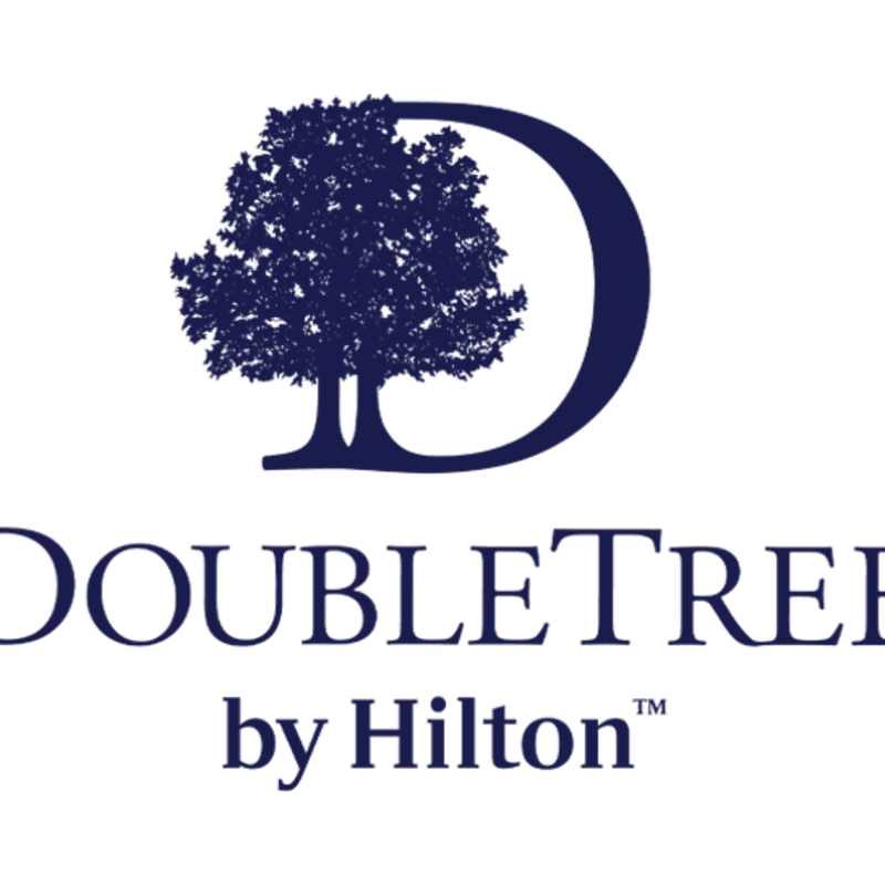 A dark blue tree silhouette is superimposed on a large, incomplete circle, with the words "DOUBLETREE by Hilton" in dark blue text below, all against a white background.