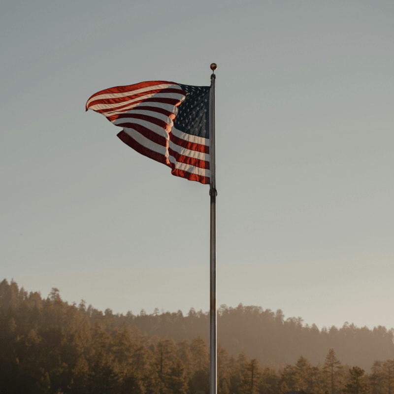 us a flag on pole during daytime